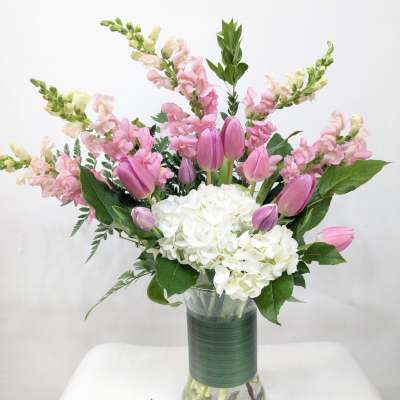 Pink tulips and white hydrangeas in a glass vase