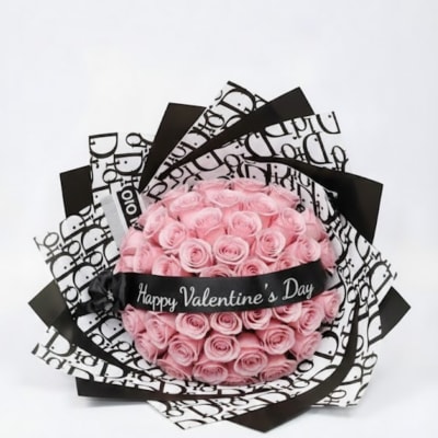 Pink rose bouquet wrapped in black-and-white paper with a Valentine ribbon