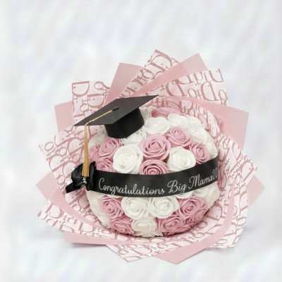 Pink and white rose bouquet with a graduation cap topper