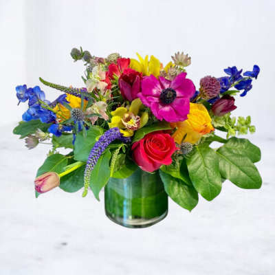 Colorful mixed bouquet in a green glass vase