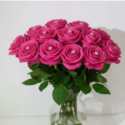 Pink roses arranged in a clear glass vase