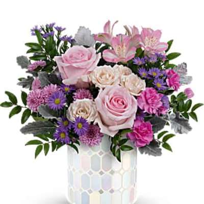 Pink roses and purple flowers arranged in a mosaic vase