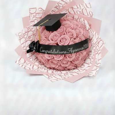 Pink rose bouquet with a graduation cap and congratulatory ribbon