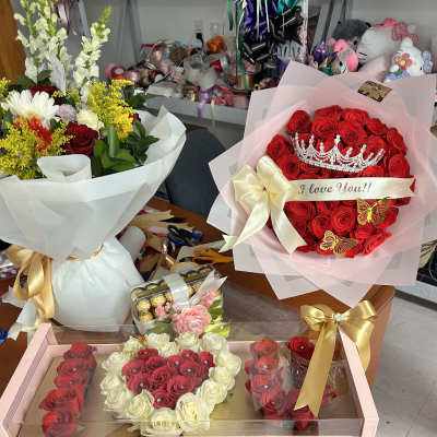 Bouquets and rose gift boxes with ribbons and a crown decoration