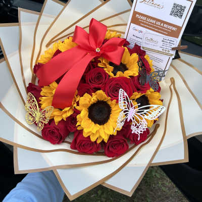 Bouquet of red roses and sunflowers with a large red bow
