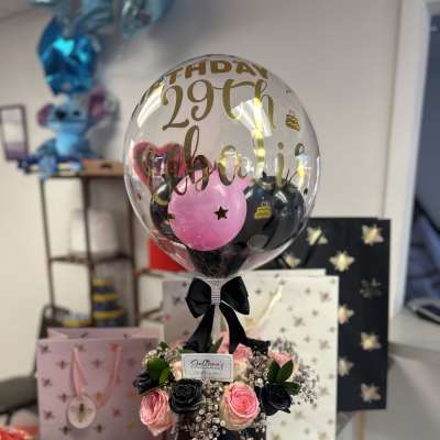 Birthday balloon arrangement with pink and black roses in a black box