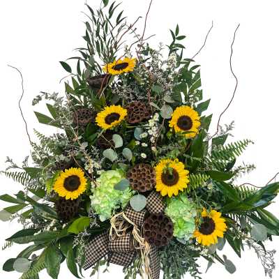 Large sunflower arrangement with green hydrangeas and a plaid bow