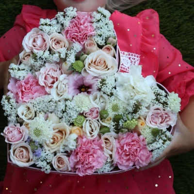 Round bouquet of pink and cream roses with carnations and white filler flowers
