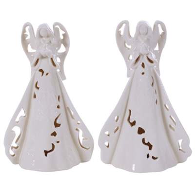 Pair of white ceramic angel figurines with cutout details on their gowns