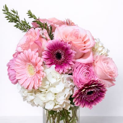 Pink and white mixed bouquet in a clear glass vase