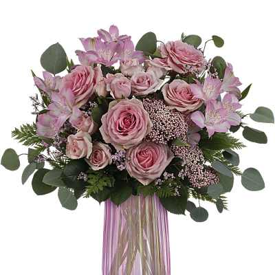 Pink roses and alstroemeria in a pink glass vase