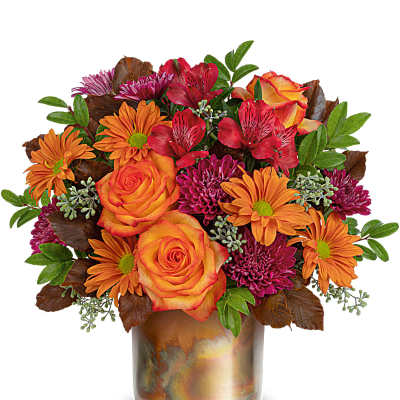 Orange and magenta mixed bouquet in a metallic vase