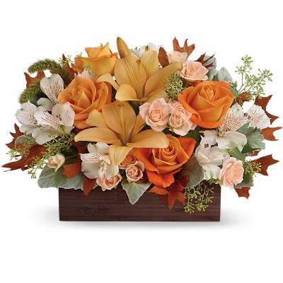Orange and peach roses with lilies in a rectangular wooden container