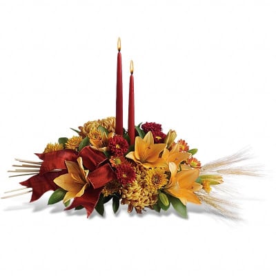 Autumn floral centerpiece with two red taper candles