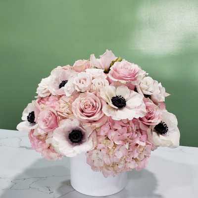 Pink and white floral arrangement in a white vase