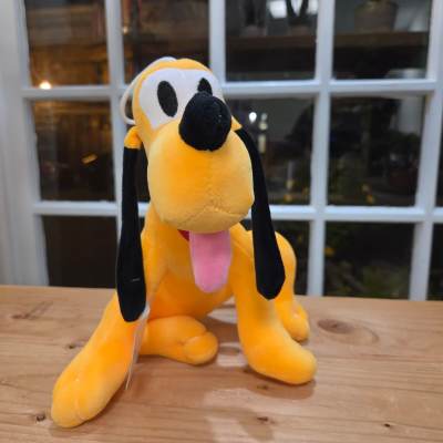 Plush yellow dog with black ears and pink tongue