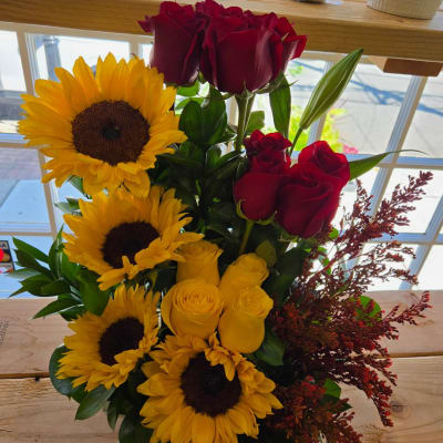 Bouquet of sunflowers and red and yellow roses