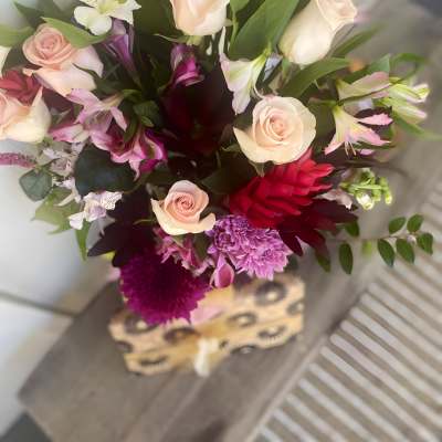 Mixed bouquet of pale roses, pink alstroemeria, and purple blooms