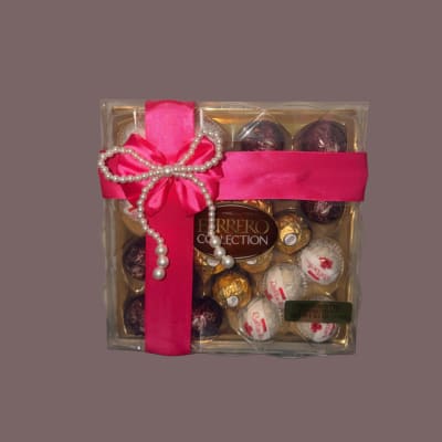 Box of Ferrero Rocher chocolates tied with a pink ribbon and pearl bow