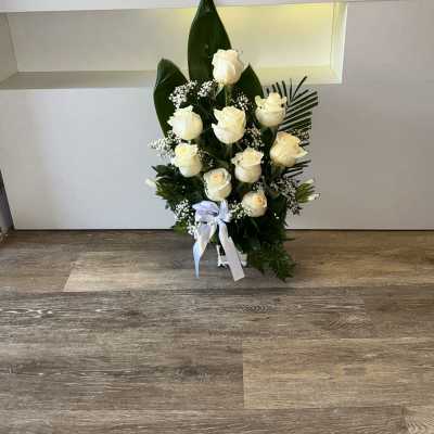 funeral base with white roses