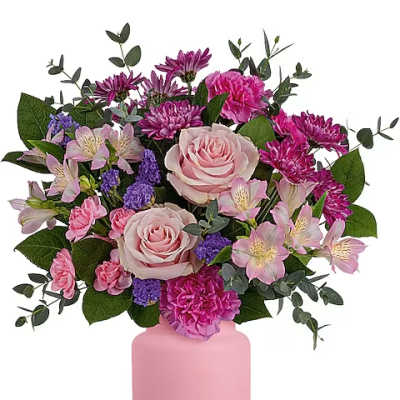 Pink roses and mixed blooms in a pink vase
