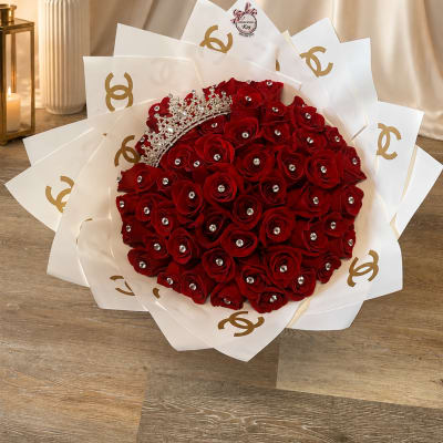 Bouquet of red roses with a jeweled crown and white wrap