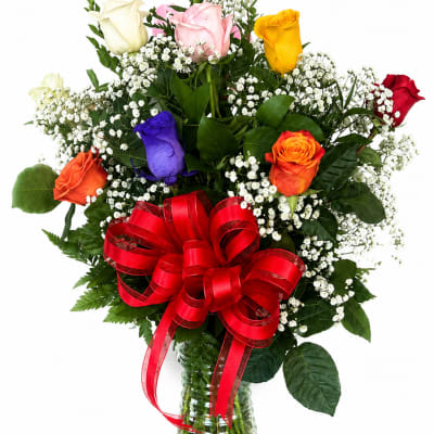 Mixed roses in a glass vase with a red ribbon bow