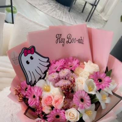 Pink bouquet with roses, daisies, and white flowers in pink wrap