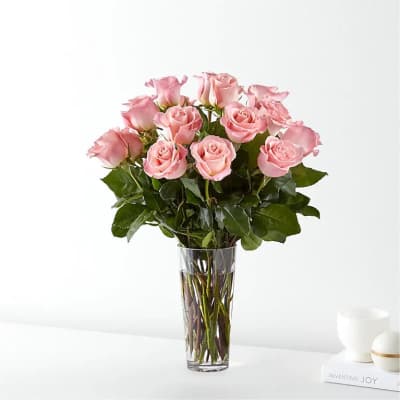 Pink roses arranged in a clear glass vase