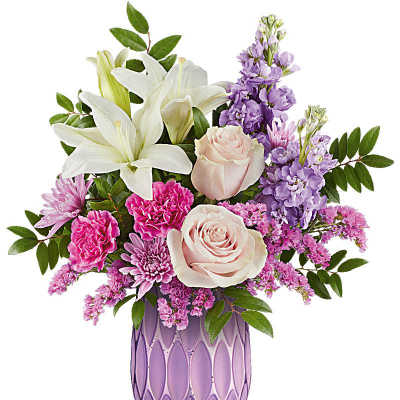 Pastel bouquet of lilies, roses, carnations, and mums in a textured lavender vase