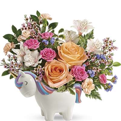 Colorful bouquet of peach roses, pink blooms and white lilies in a ceramic unicorn container