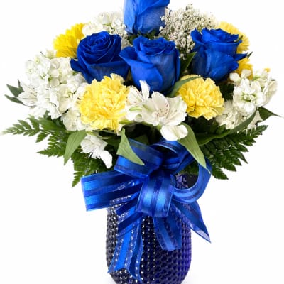 Blue roses and white-yellow flowers in a blue vase with ribbon