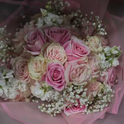 Pink and cream rose bouquet wrapped in pink paper