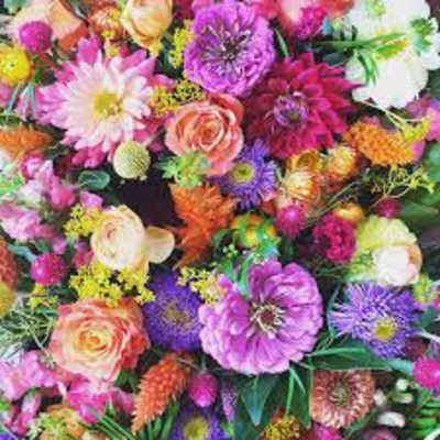 Colorful bouquet of mixed flowers with pink, purple, orange, and white blooms