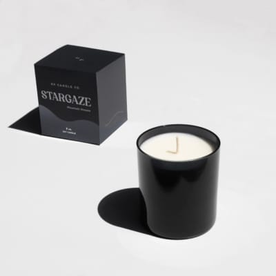 Black candle in a glass jar with a matching box