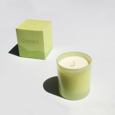 Green candle in a glass jar with matching box