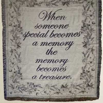 Decorative memorial throw blanket with a printed quote and floral border