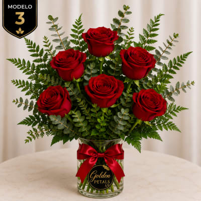 Bouquet of red roses in a glass vase with a red ribbon