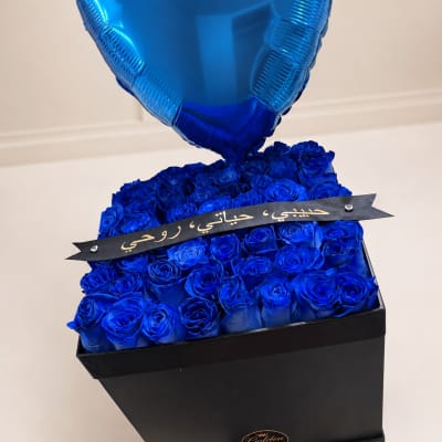 Blue roses in a black box with a blue heart balloon