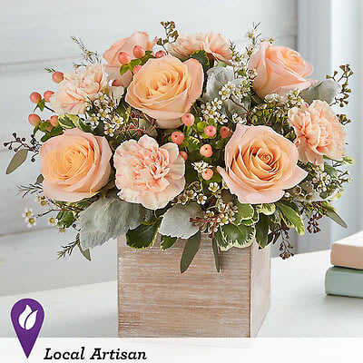 Peach roses and carnations in a wooden box arrangement