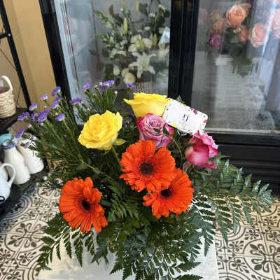 Bouquet of orange gerbera daisies and pink and yellow roses