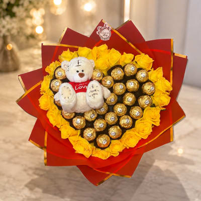 Bouquet of yellow roses with a teddy bear and wrapped chocolates