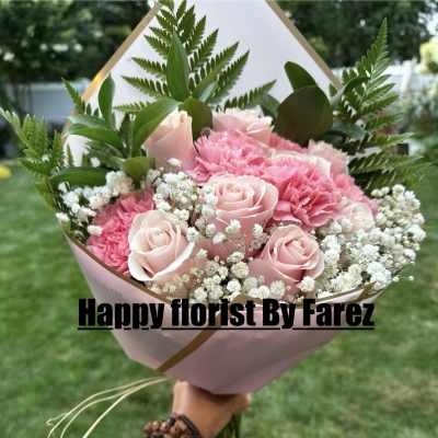 Pink rose and carnation bouquet with baby's breath in pink wrap