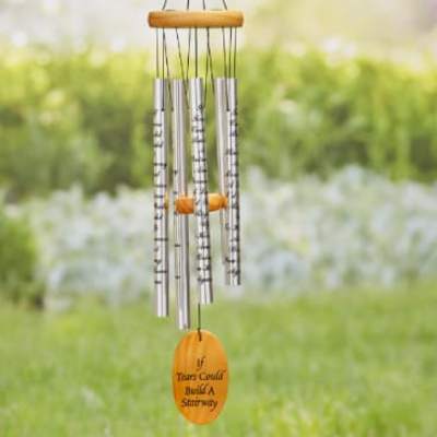 Hanging metal wind chime with a wooden top and orange memorial tag