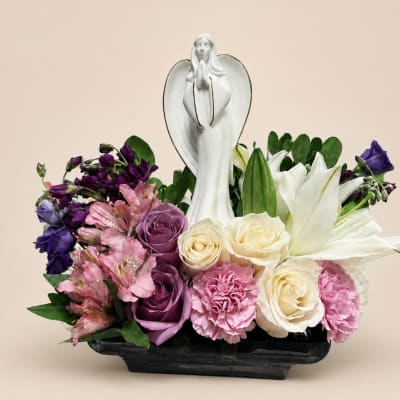 Floral arrangement with a white angel figurine in a black vase