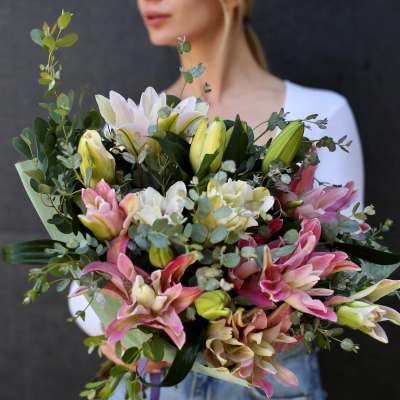 Bouquet of pink and white lilies with eucalyptus greenery