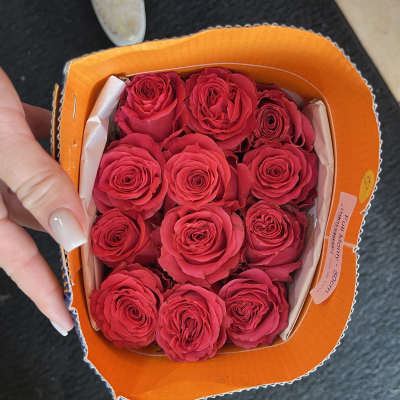 A small box of bright pink roses arranged tightly together