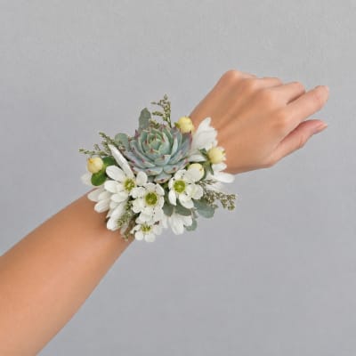 White floral wrist corsage with a succulent center