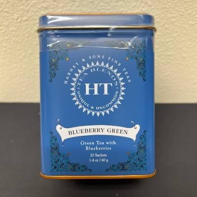 Blue tin of blueberry green tea on a table