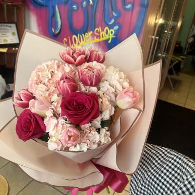 Pink and white bouquet with roses and tulips wrapped in blush paper